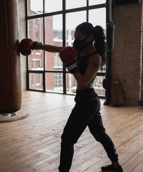 Athletic man in a focused pose during a strength exercise.